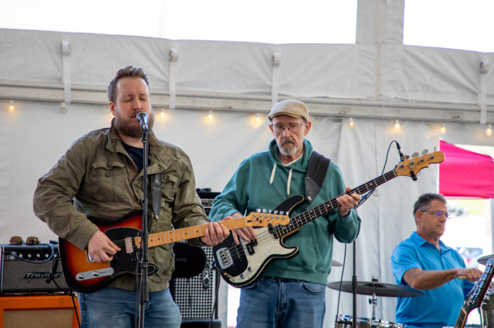 Two band members playing guitar at Annual Meeting 2025