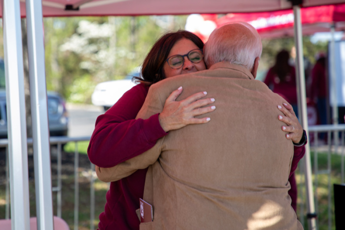 Credit union employee and member hugging